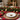 Christmas table setting with a dog-themed plate, candles, and festive decorations.