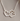 Silver necklace with a heart and paw print design on a white background