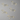 Set of five gold dachshund-shaped paper clips on a white background