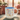 Mug with 'DOGS MAKE LIFE BETTER' text and floral design on a wooden surface.