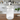 Clear glass jar with a white lid featuring a black and white dog figurine on a white background