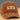 Brown cap with 'All You Need Is Love And A Dog' text on a white background