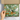 Box with a green wrapping paper featuring illustrations of dogs, held by a hand.