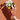 Bouquet of flowers wrapped in red paper with animal pattern against a brown background