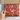 Box with a red holiday-themed paper featuring illustrations of dogs on a neutral background