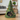 Green felt pet bed shaped like a Christmas tree with colorful pom-poms, featuring a cat inside.