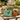 Miniature plant pots with decorative animals and a box labeled 'Adorable Dogs' in front.