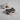 Two dog toys shaped like gingerbread men and houses on a gray surface