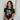 Woman wearing a black t-shirt with 'Dogs. Coffee. Couch. Me.' text.