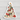 Christmas tree-shaped sticker with cartoon dogs wearing sweaters and surrounded by lights on a wooden surface.