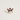 A small enamel pin shaped like a French bulldog wearing a red Santa hat with white faux pearls, shown on a plain light beige background.