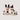 Two ceramic dog figurines with collars on a white background