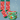 Red socks with dog pattern and green mug with matching design on a white background