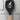 Black spatula with a wooden handle and humorous text design on a white background