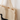 Cream-colored canvas tote bag with bold black silhouette of a standing dog and wagging tail, made from organic cotton