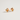 A pair of gold-toned stud earrings shaped like corgi dog heads, decorated with white enamel, orange-brown accents, and small colorful gemstone details, photographed on a clean light gray background.