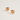 A pair of gold-plated stud earrings shaped like corgi dog faces wearing red and green Christmas hats, displayed on a clean off-white background.