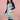 Person wearing a colorful apron with animal patterns against a pink background