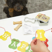 Load image into Gallery viewer, Dog Party Kit Featuring A Dog Treat Recipe Book Bone Shaped Cookie Cutter Banner Confetti And A Birthday Hat